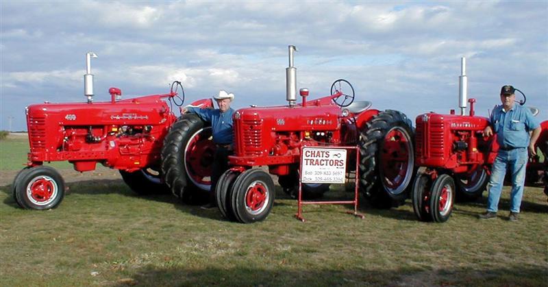 Bob and Dick Chatterton standing witha few of their Restored Farmall Tractors